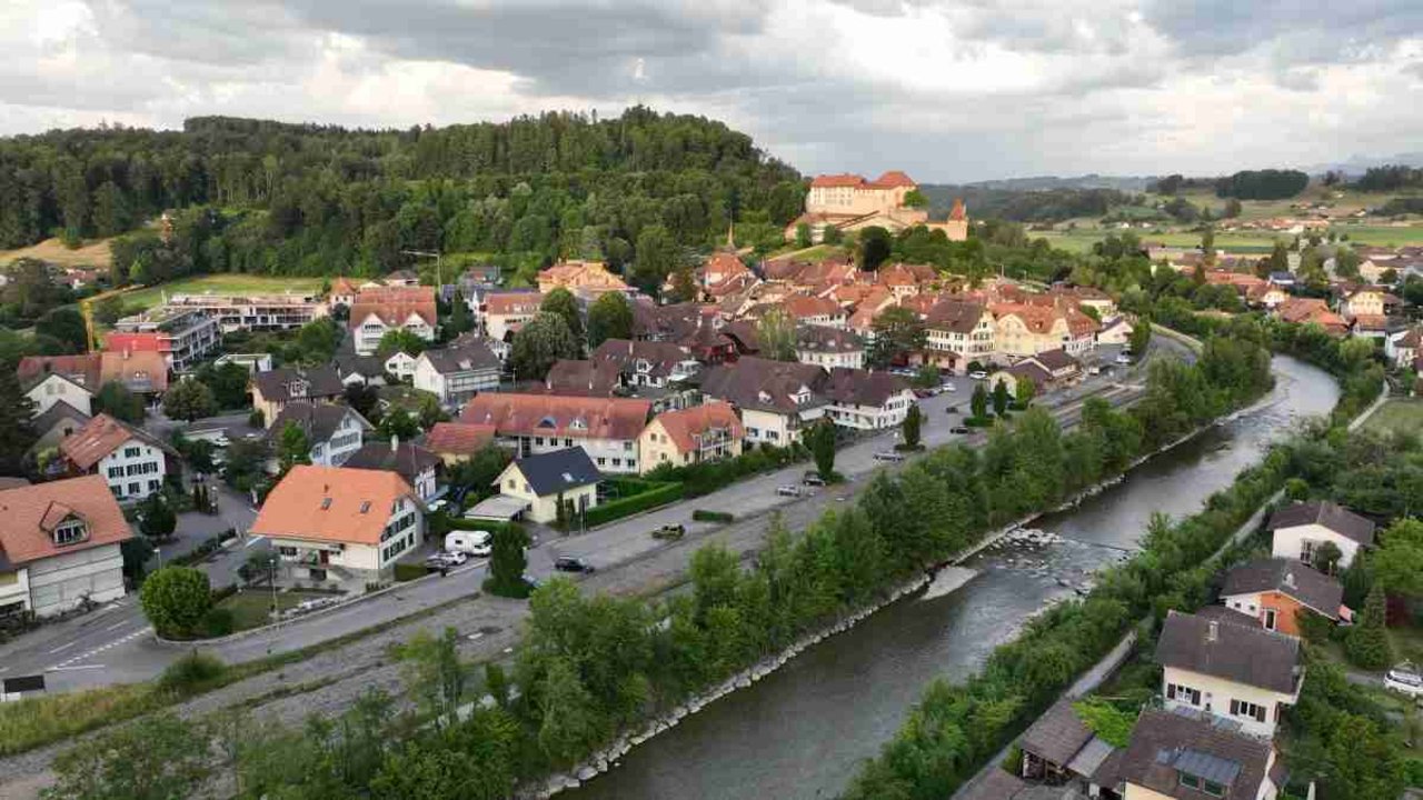 Luftaufnahme von Laupen mit Stedtli und Schloss im Hintergrund